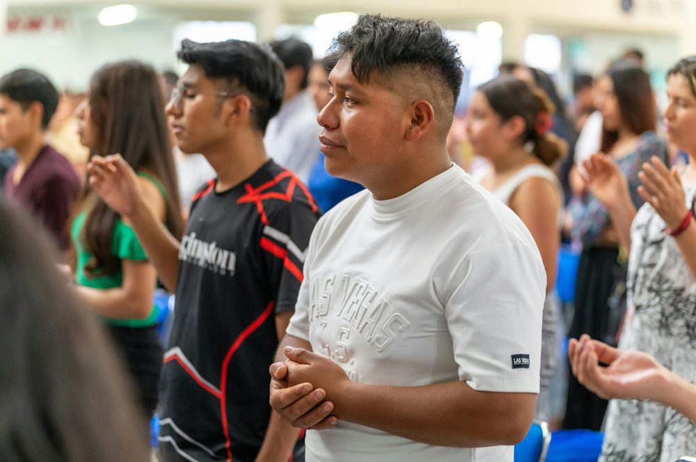 Young Hispanic listening to preaching